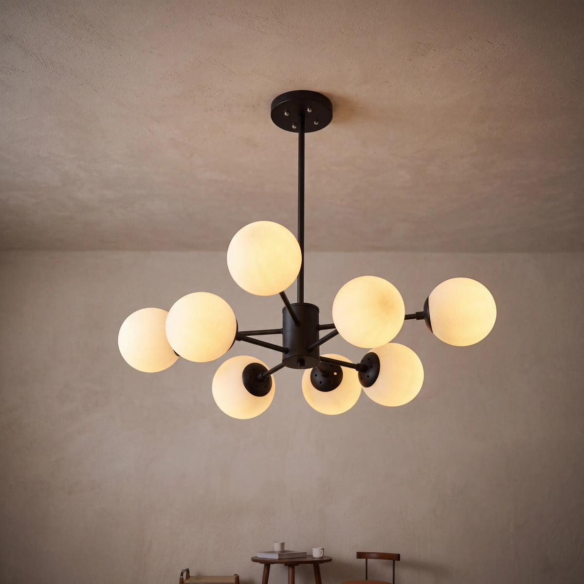 Modern glass globe chandelier with 8 lights and a black frame, lit above a dining table
