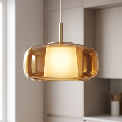 Close up of amber glass kitchen island pendant light with brushed brass cap