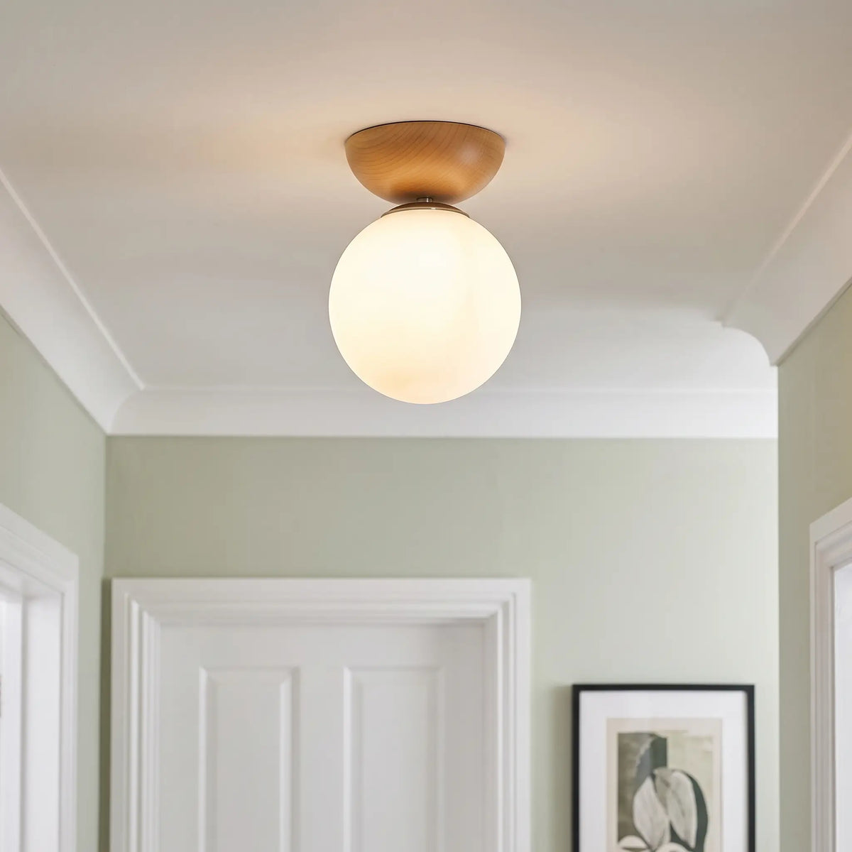 Wood and opal glass globe semi flush ceiling light – Teak – in a hallway