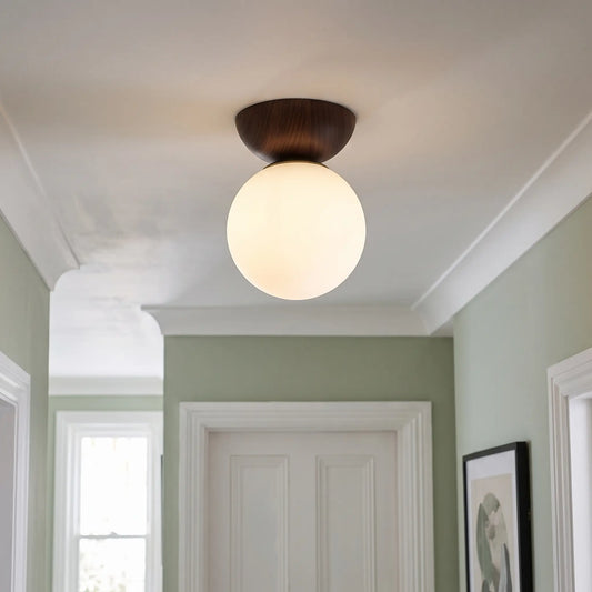Wood and opal glass globe semi flush ceiling light – Walnut – in a hallway