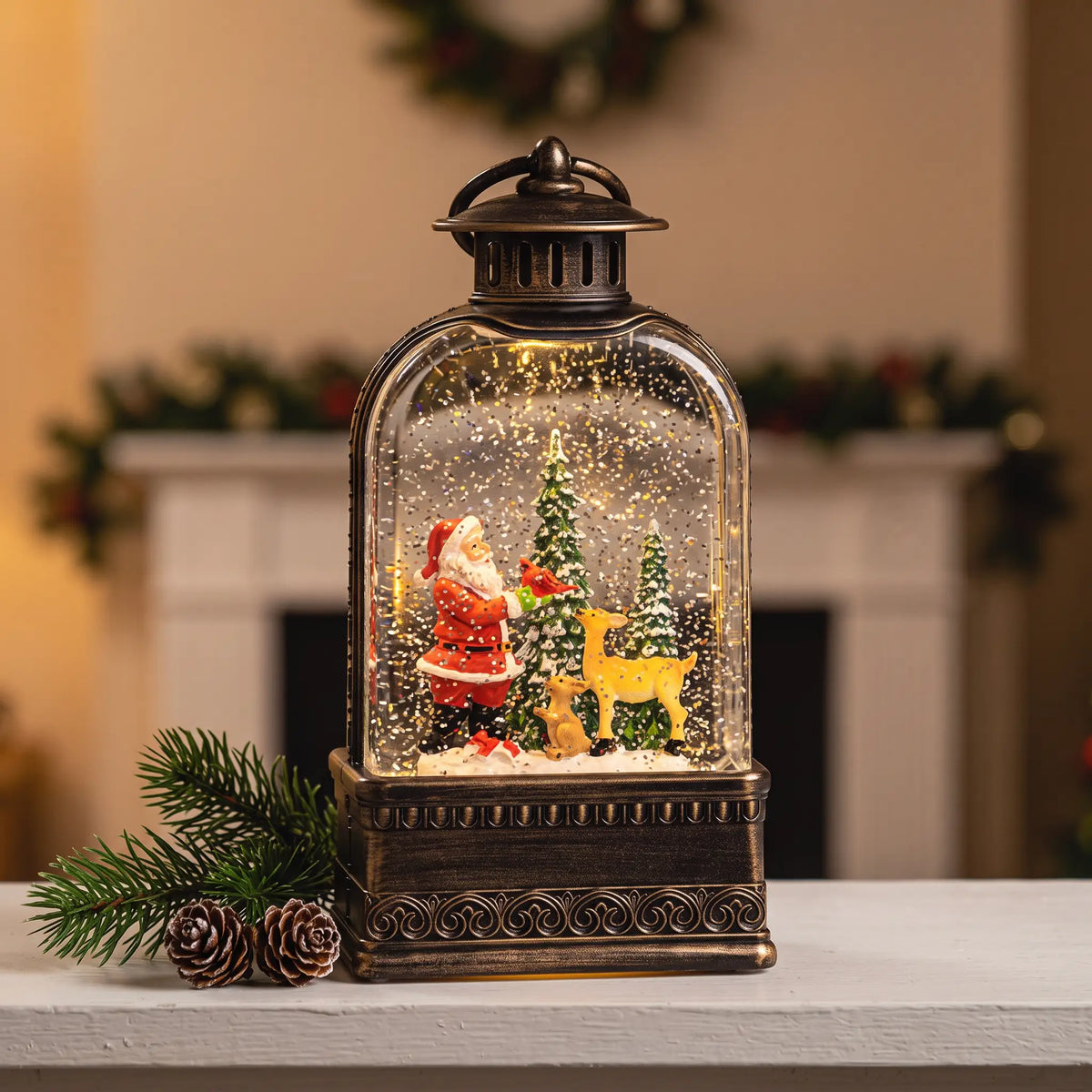 Large light-up snow globe lantern with Father Christmas and reindeer on a mantelpiece