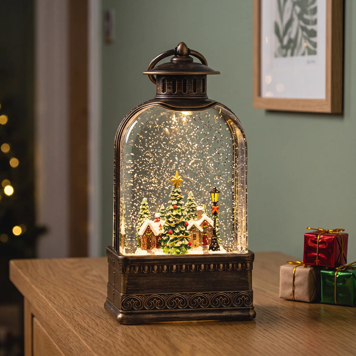 Light-up snow globe lantern with Christmas village scene