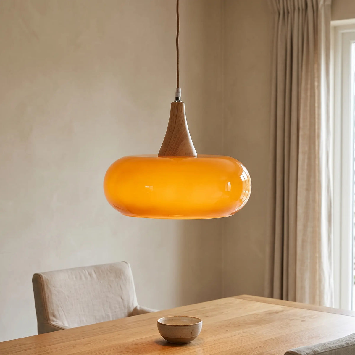 Nordic glass and wood pendant light – Amber – over a dining table