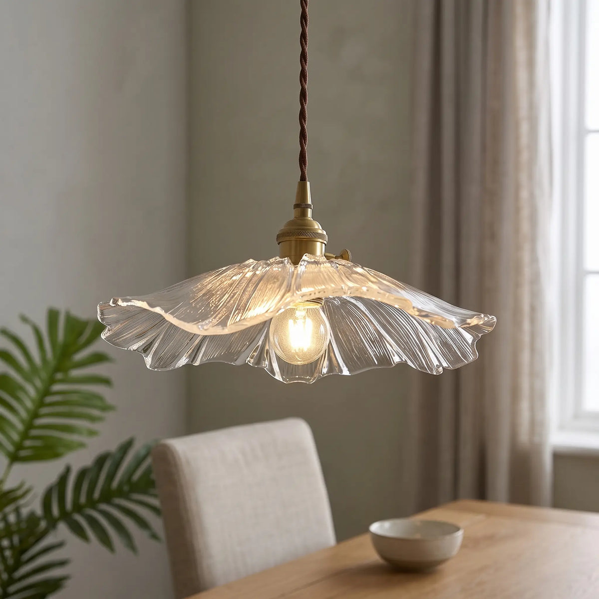 Ribbed glass lotus pendant light – Clear – over a dining table