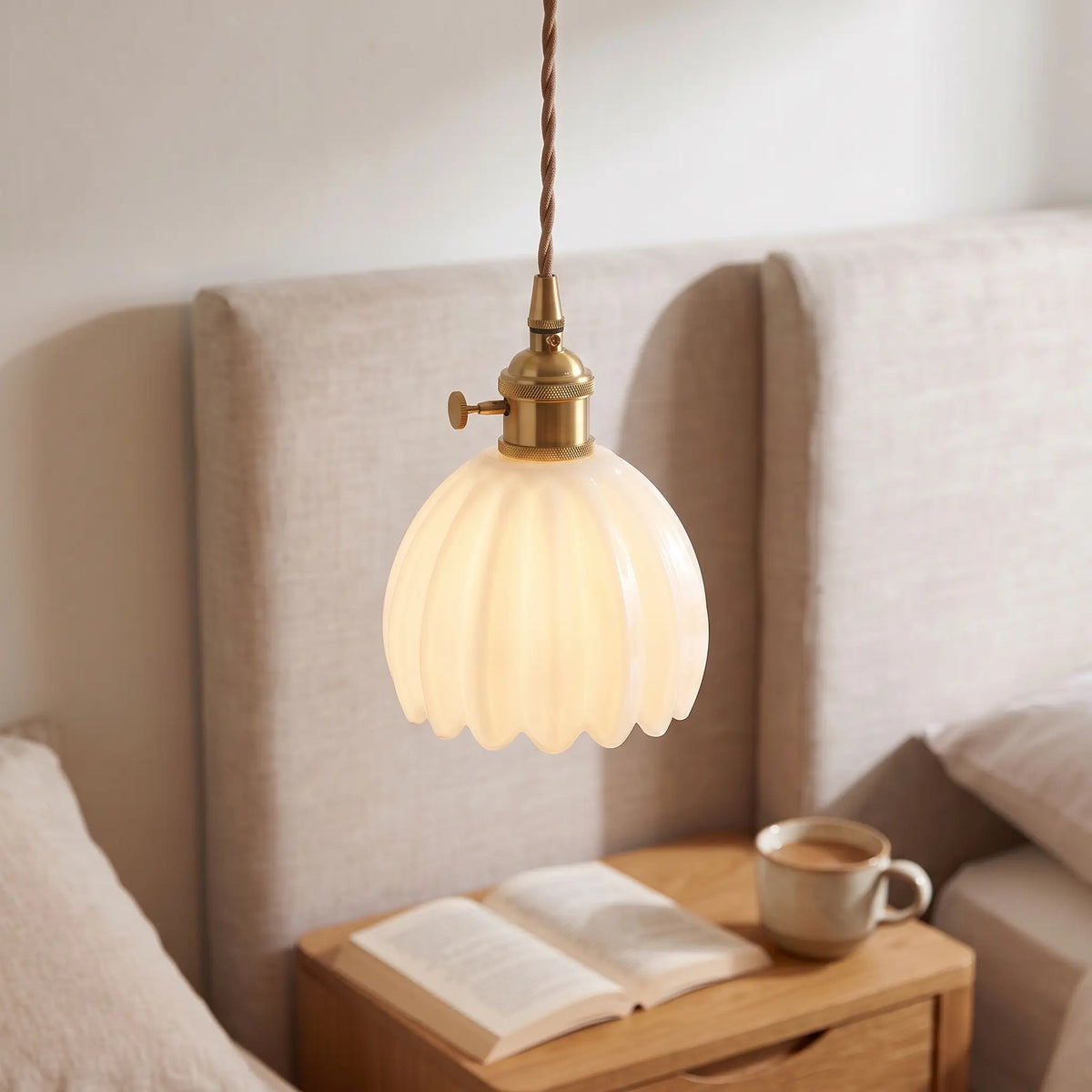 Small flower glass pendant light – Opal White – beside a bed