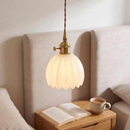 Small flower glass pendant light – Opal White – beside a bed
