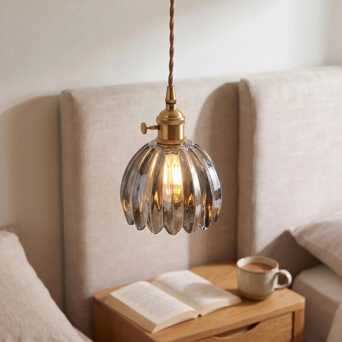 Small flower glass pendant light – Smoke Grey – beside a bed