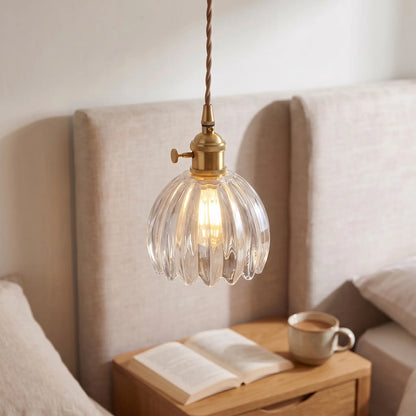 Small flower glass pendant light – Clear – beside a bed