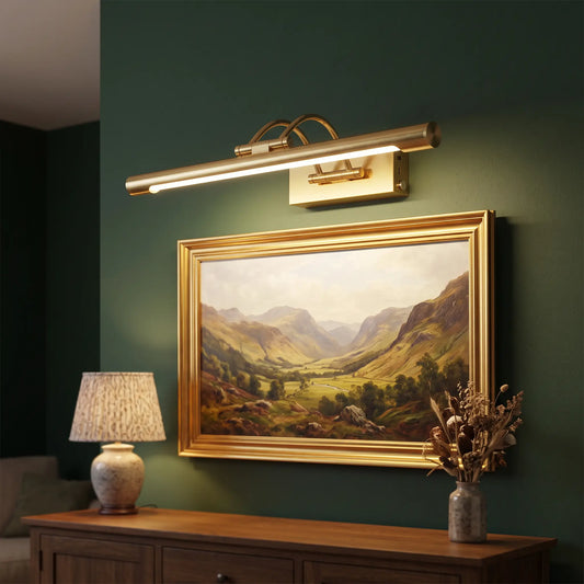 Rechargeable brass picture light lighting an oil painting on a green wall