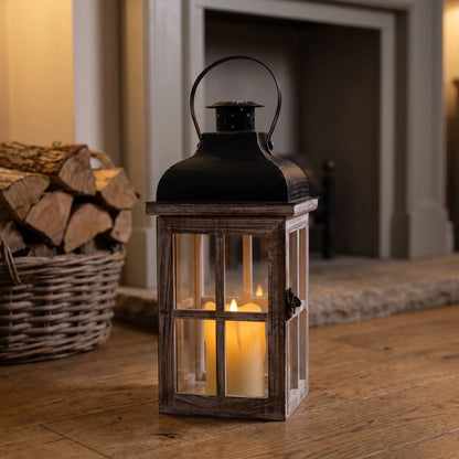 Large wooden candle lantern with black roof beside a fireplace, 38cm