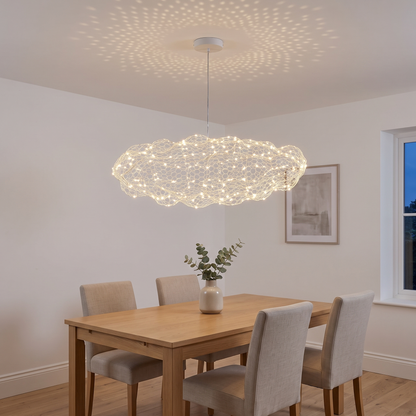 Silver wire mesh cloud pendant light glowing warm white over an oak dining table, scattering starry light dots across the ceiling of a UK dining room