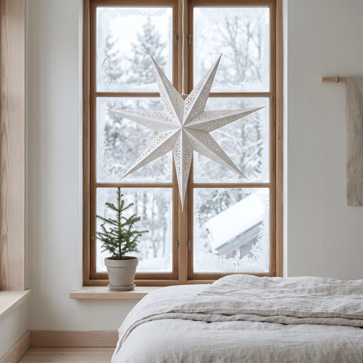 Large 60cm white paper star lantern hanging in a bedroom window