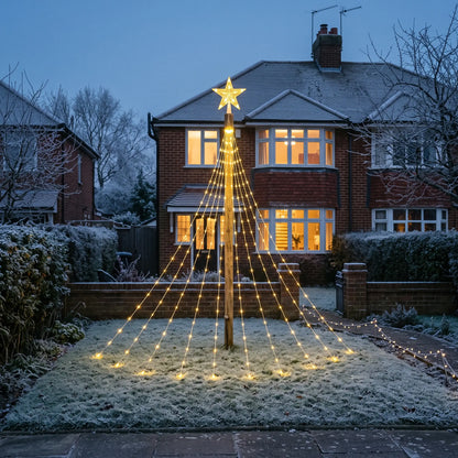 Warm white star waterfall outdoor Christmas tree lights in a front garden at dusk