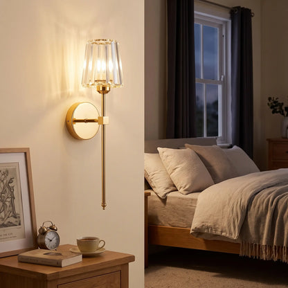 Gold crystal glass rechargeable wall sconce above a bedside table