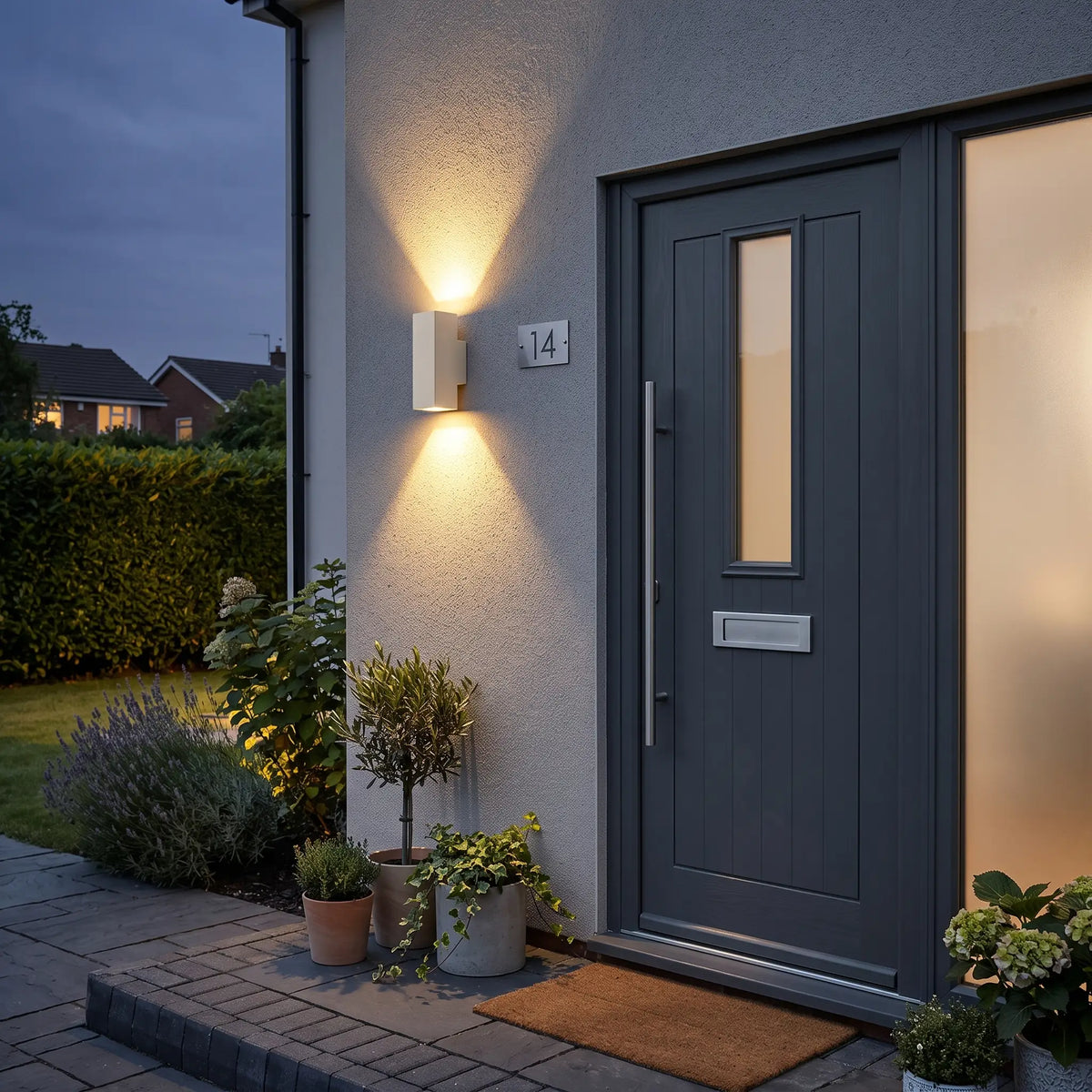 Square sand white up down outdoor wall light beside a front door
