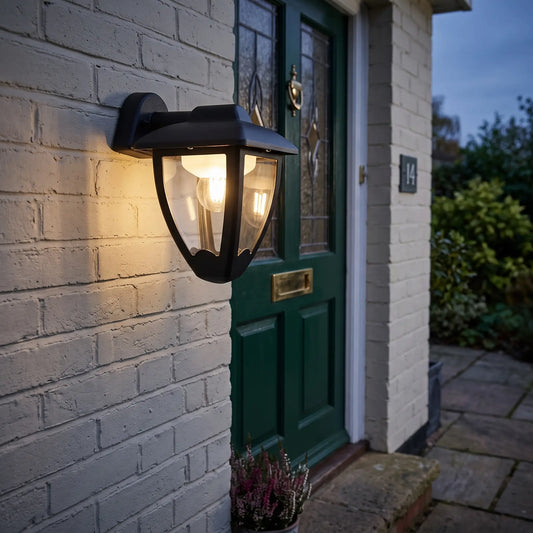 Black coach lantern outdoor wall light on a porch