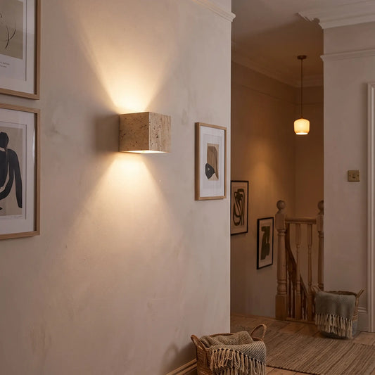 Travertine cube up down wall light on a landing