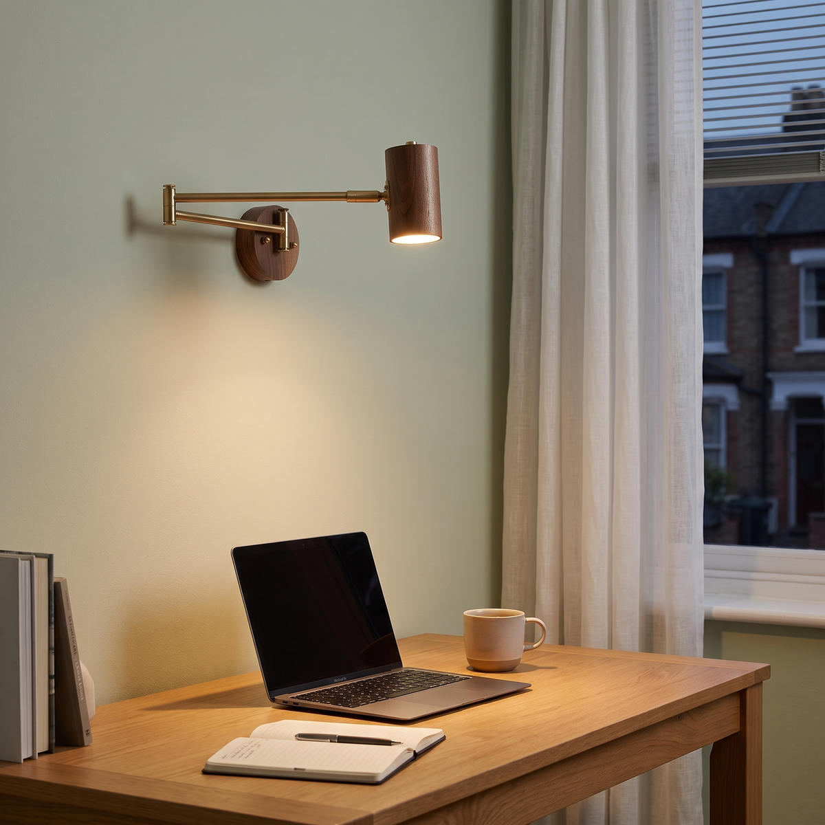 Walnut swing arm wall light above a home office desk
