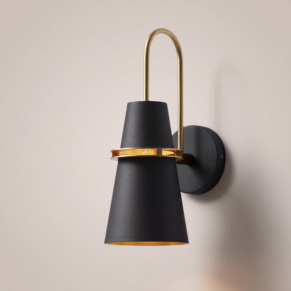 Black Nordic cone wall light with brass ring, studio product photo