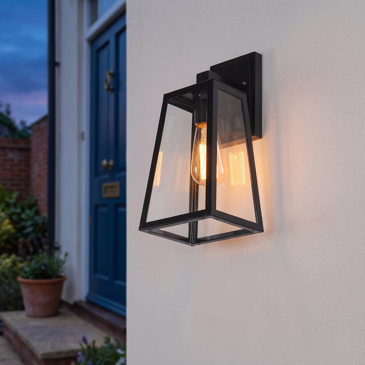 Black tapered outdoor wall lantern 35cm, close-up beside a front door
