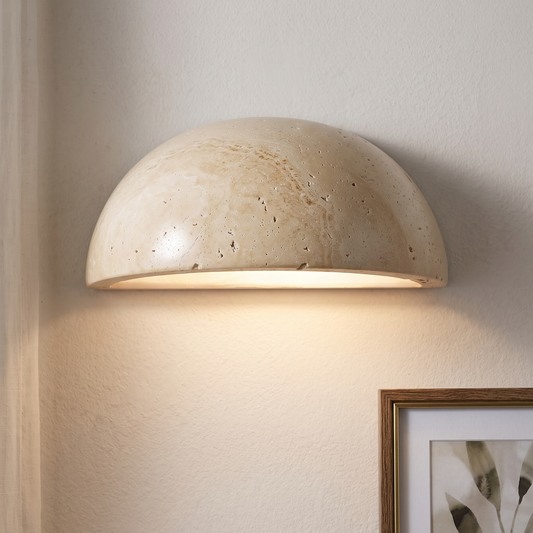 Half moon travertine wall light straight-on, natural stone texture, downward light