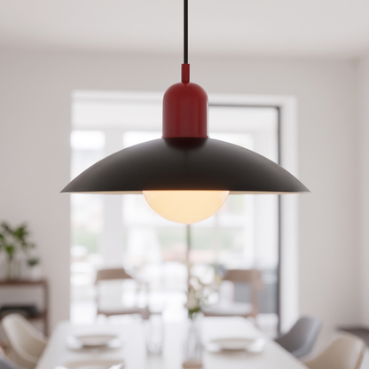 Bauhaus macaron saucer pendant light, red and black, lit over a dining table
