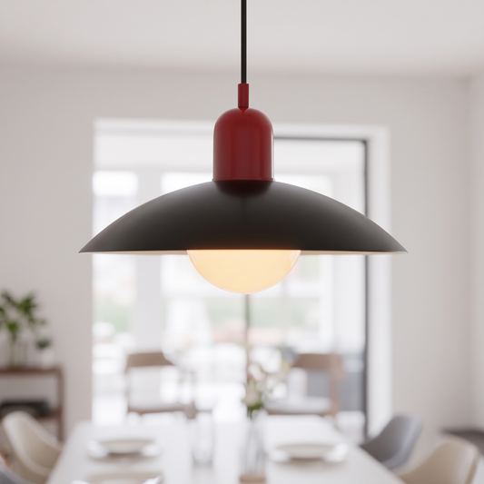 Bauhaus macaron saucer pendant light, red and black, lit over a dining table