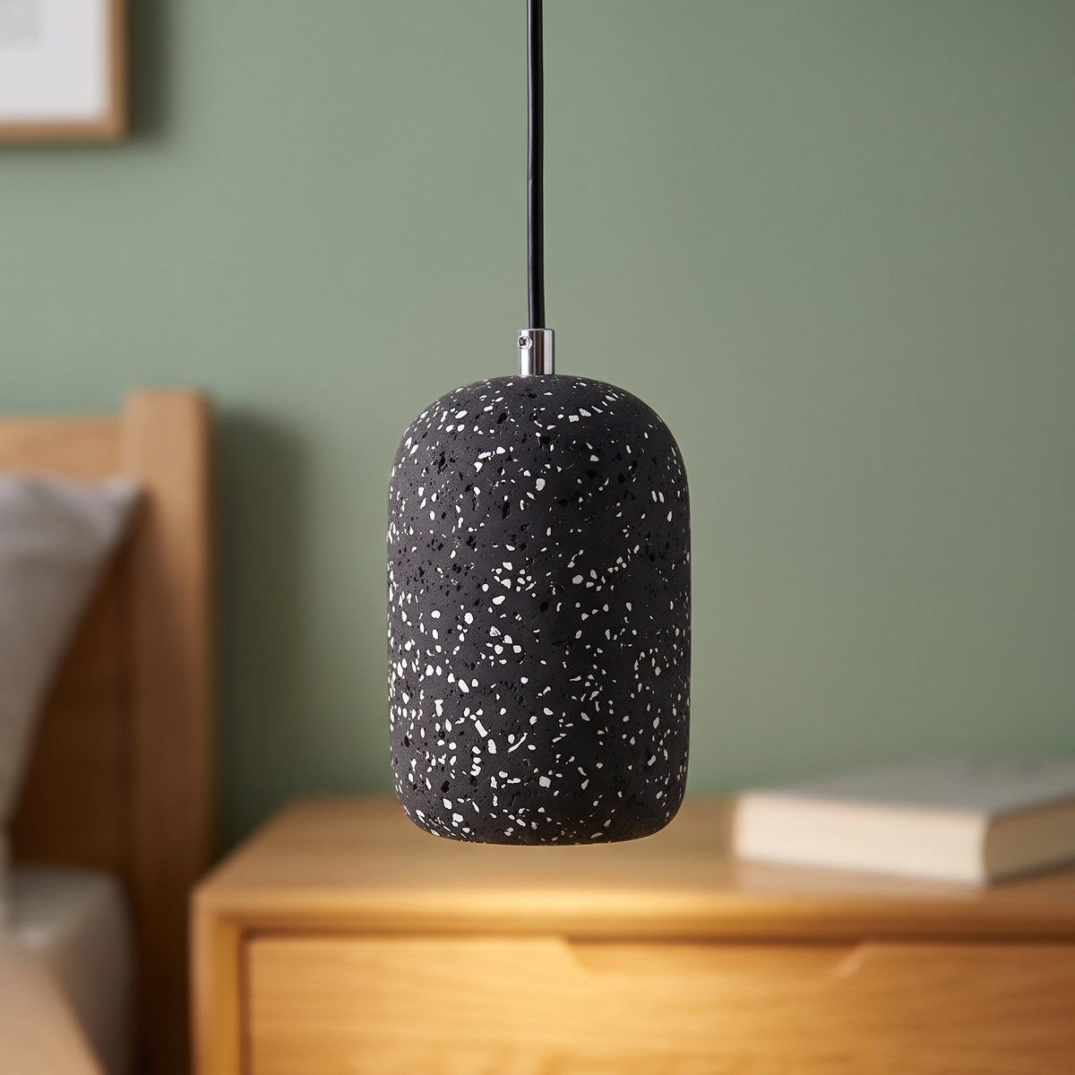 Black speckled concrete mini pendant light, close-up in a bedroom