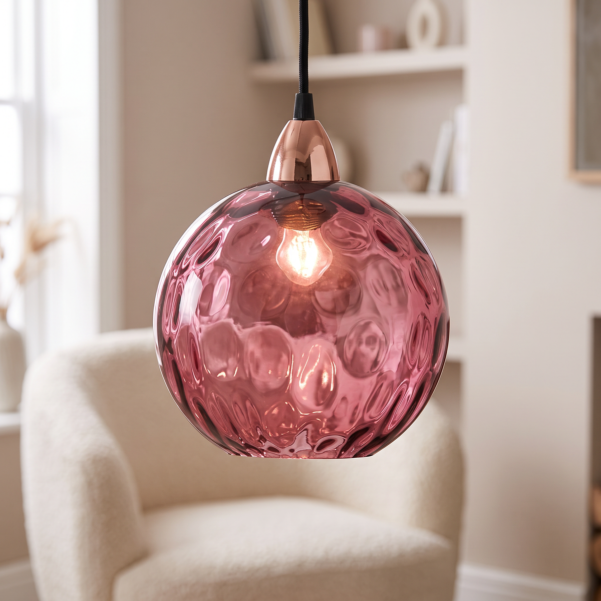 Rose pink rippled glass globe pendant light, close-up in a living room
