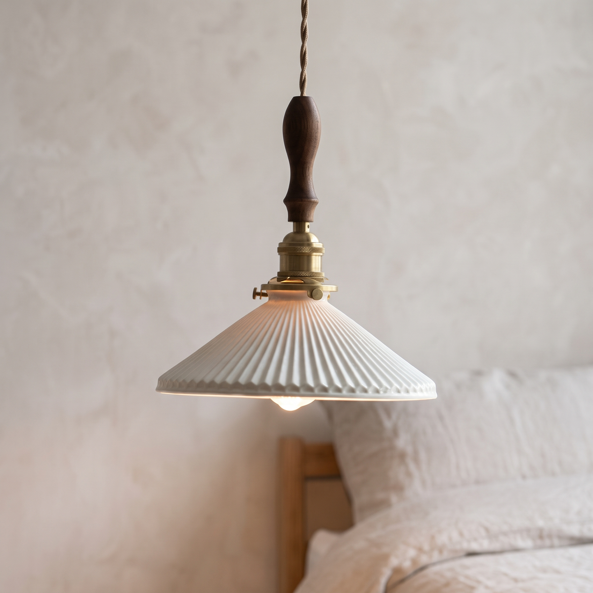 Japanese pleated ceramic pendant light with walnut wood top, close-up in a bedroom