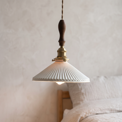Japanese pleated ceramic pendant light with walnut wood top, close-up in a bedroom