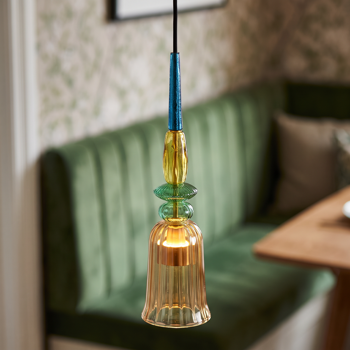 Amber ribbed glass mini pendant light, close-up in a dining nook