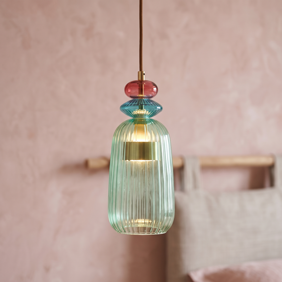 Green ribbed glass mini pendant light, close-up in a bedroom