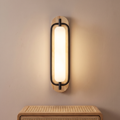 Natural wood and black capsule LED wall light, close-up beside a bed