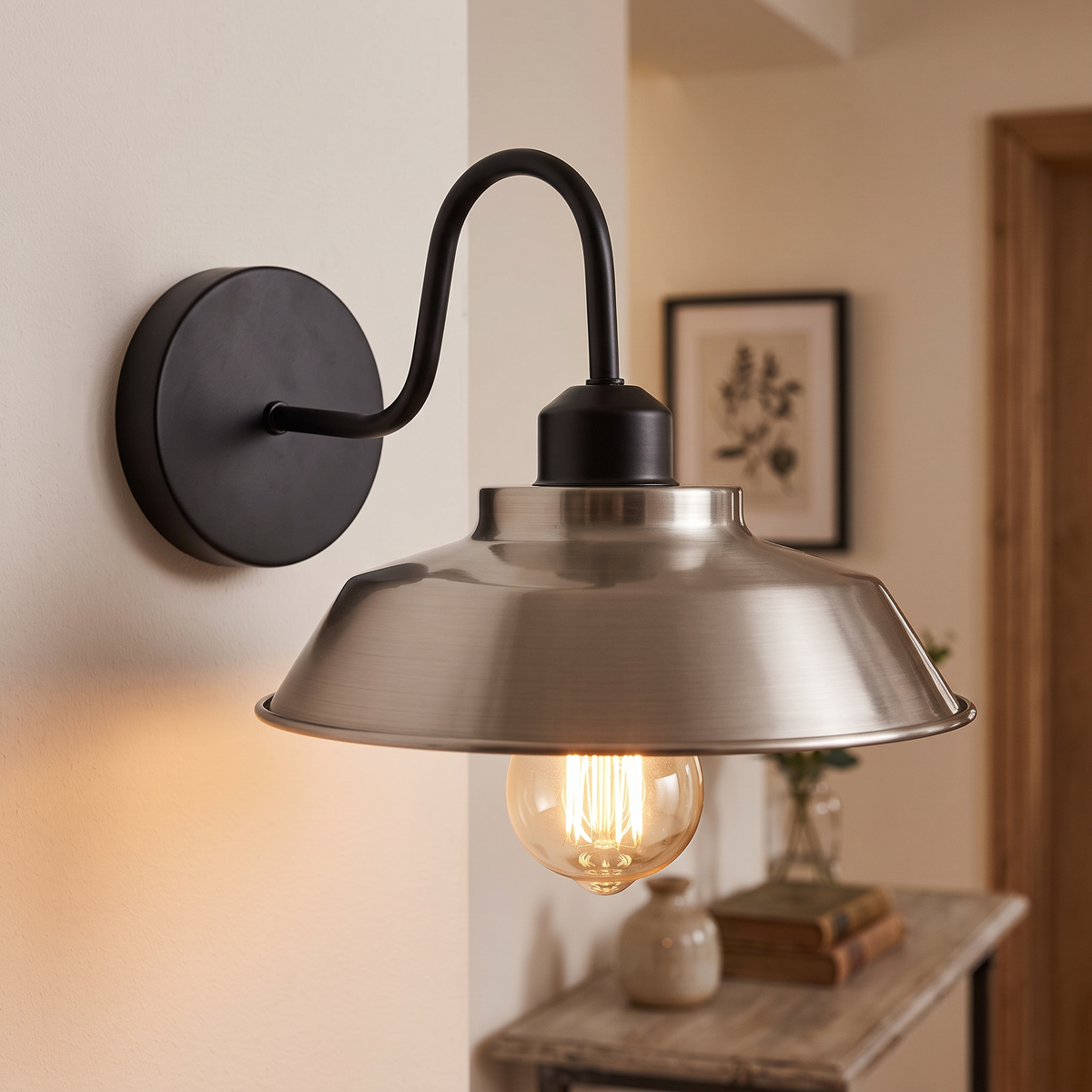 Gooseneck barn wall light with satin nickel shade in a hallway