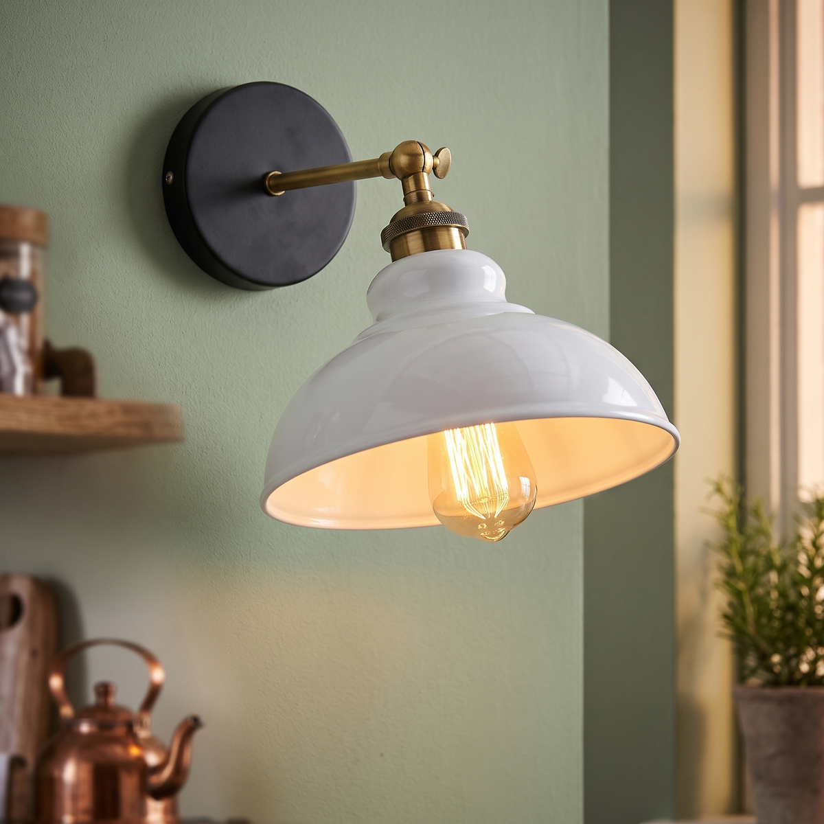 Vintage industrial dome wall light in white on a sage green kitchen wall