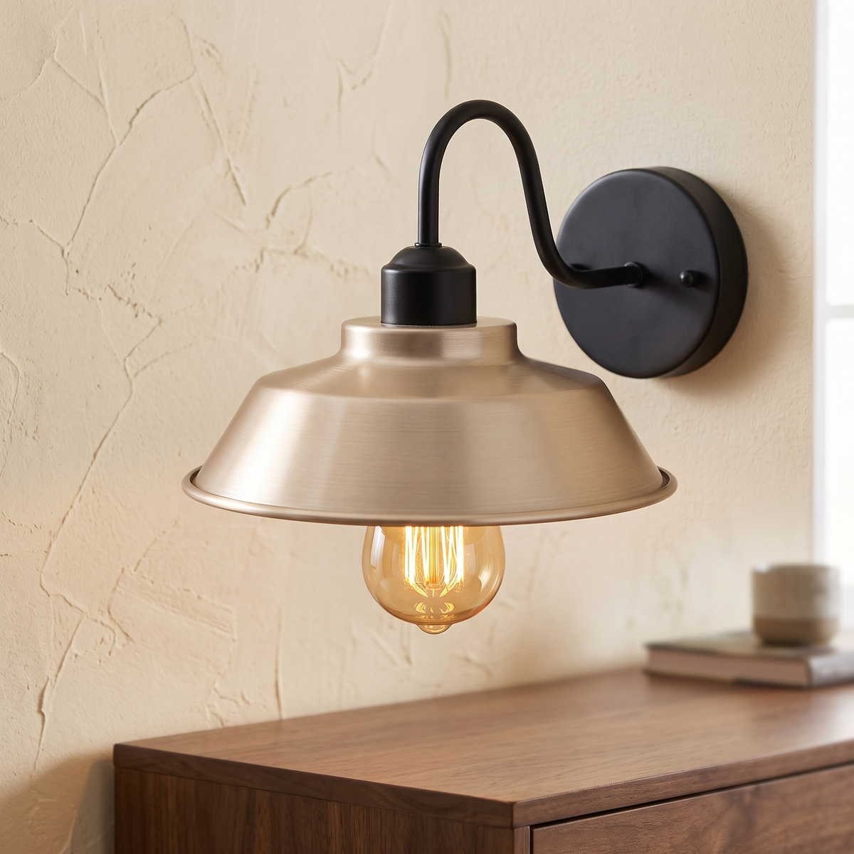 Gooseneck barn wall light with French gold shade above a dresser