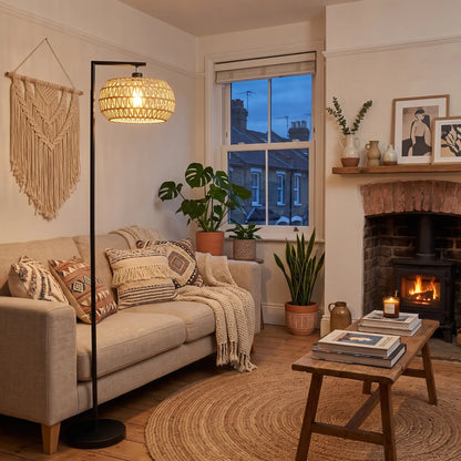 Black arc floor lamp with woven shade in a boho living room
