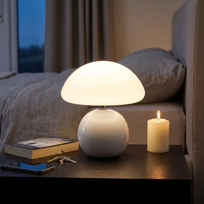 White ceramic mushroom table lamp on a nightstand