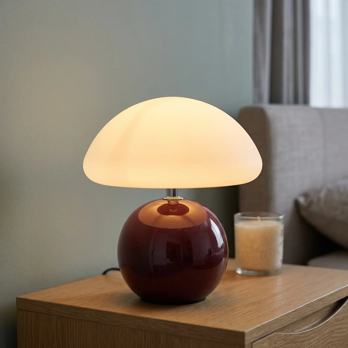 Burgundy ceramic mushroom table lamp on a nightstand