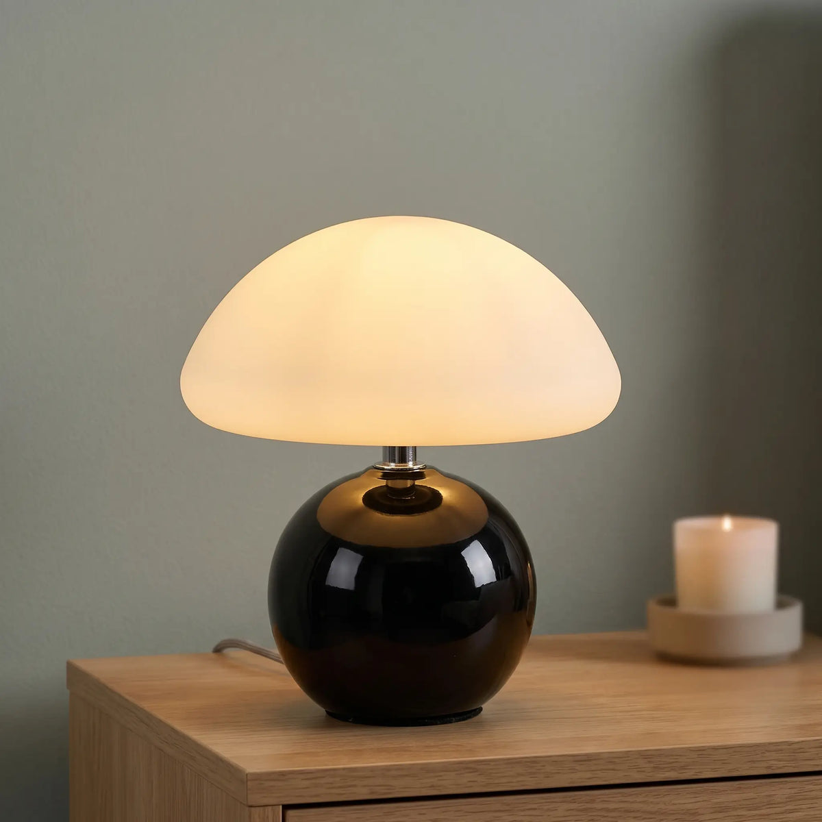 Black ceramic mushroom table lamp on a nightstand