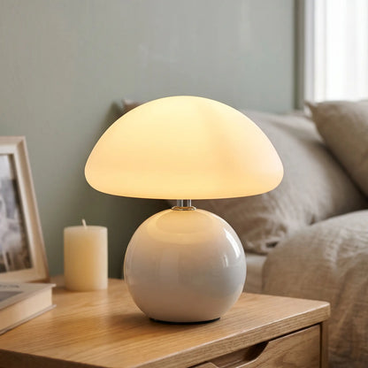 White ceramic mushroom table lamp on a nightstand
