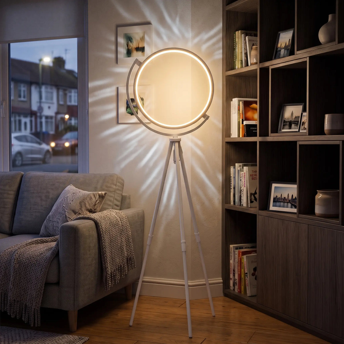 White LED ring tripod floor lamp in a living room corner