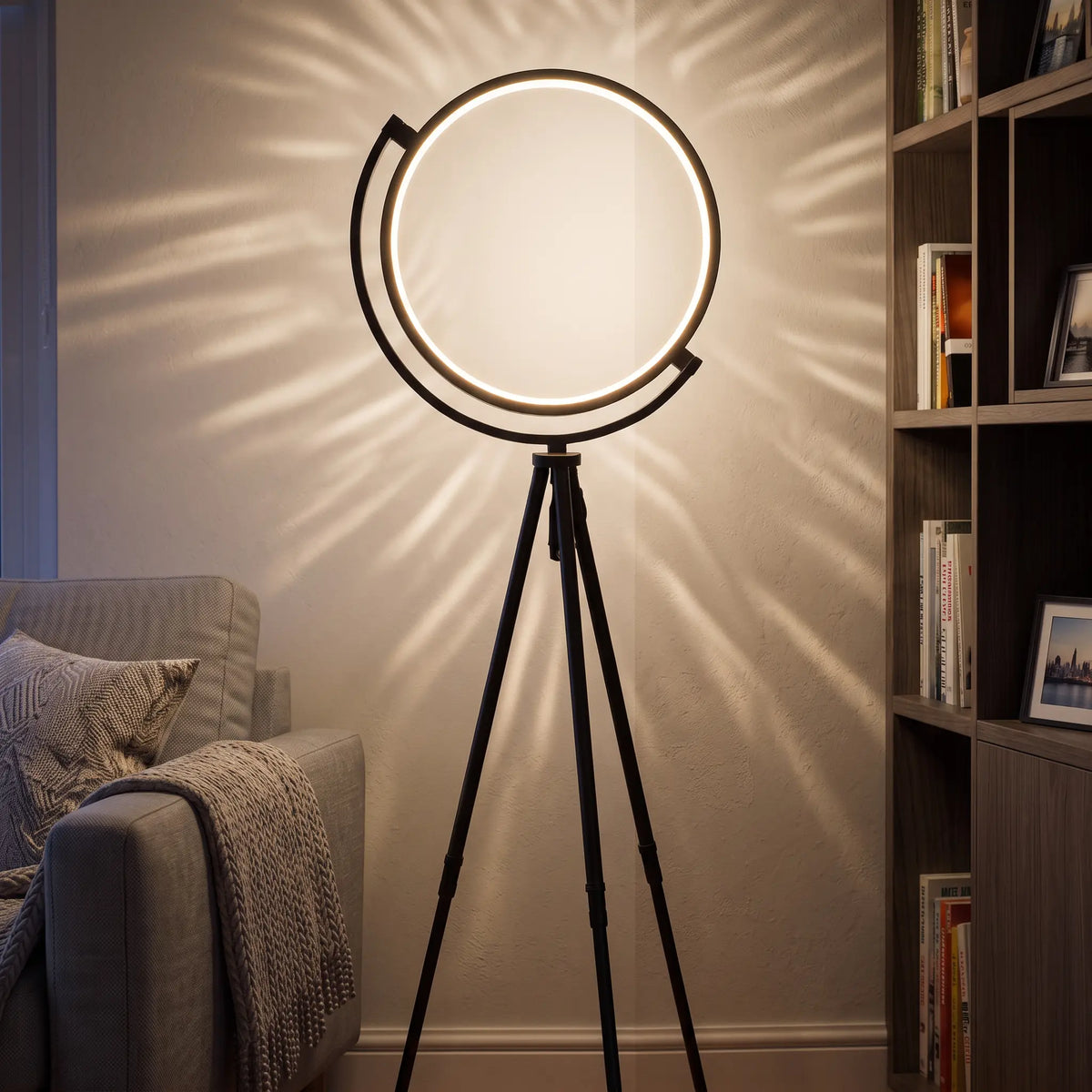 Black LED ring tripod floor lamp in a living room corner