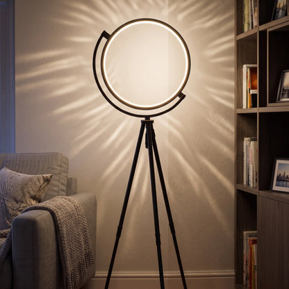 Black LED ring tripod floor lamp in a living room corner