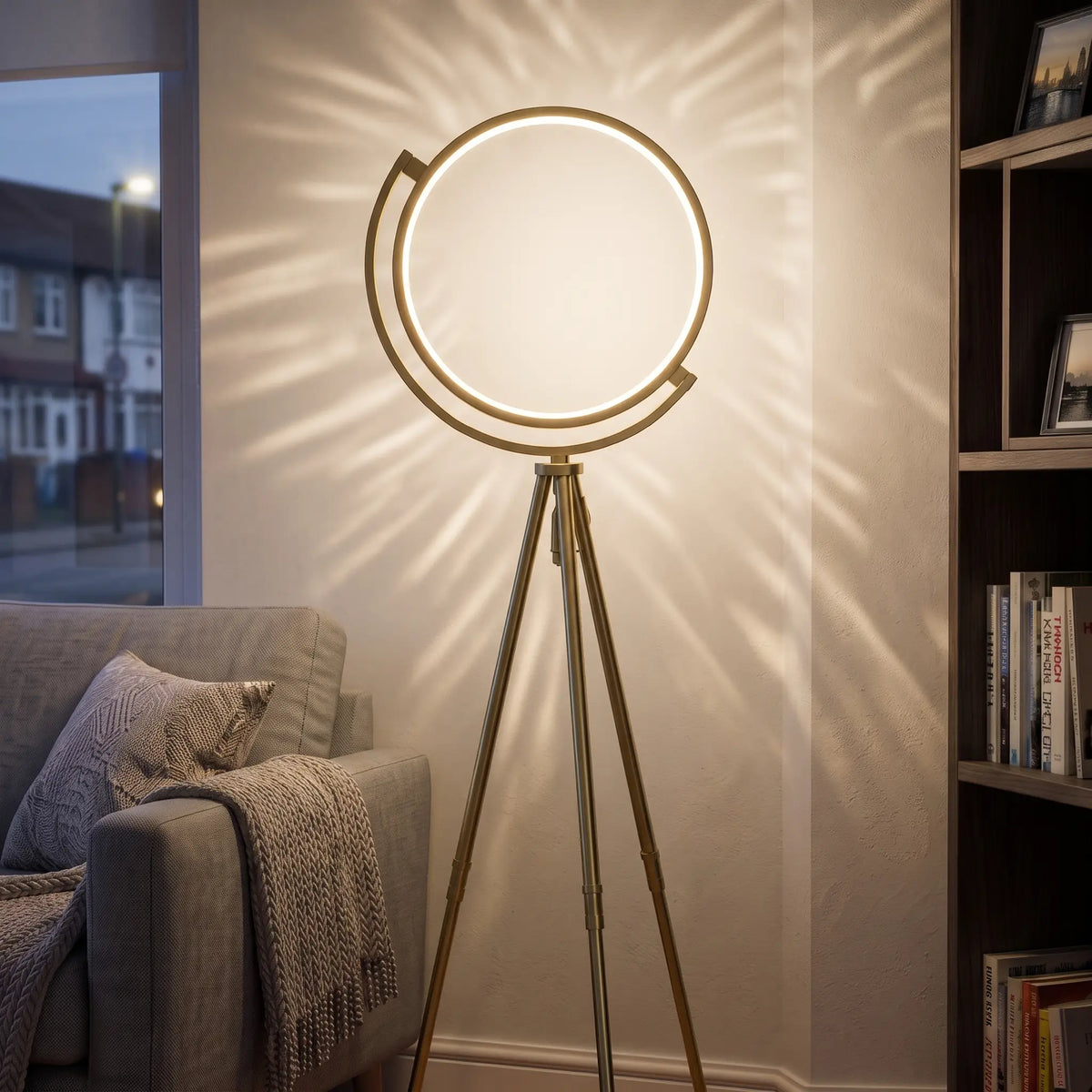 Gold LED ring tripod floor lamp in a living room corner