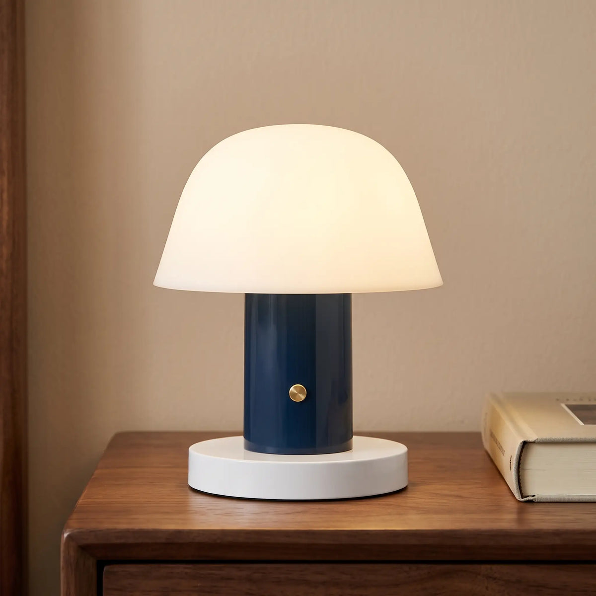 Navy blue cordless mushroom lamp on a bedside table