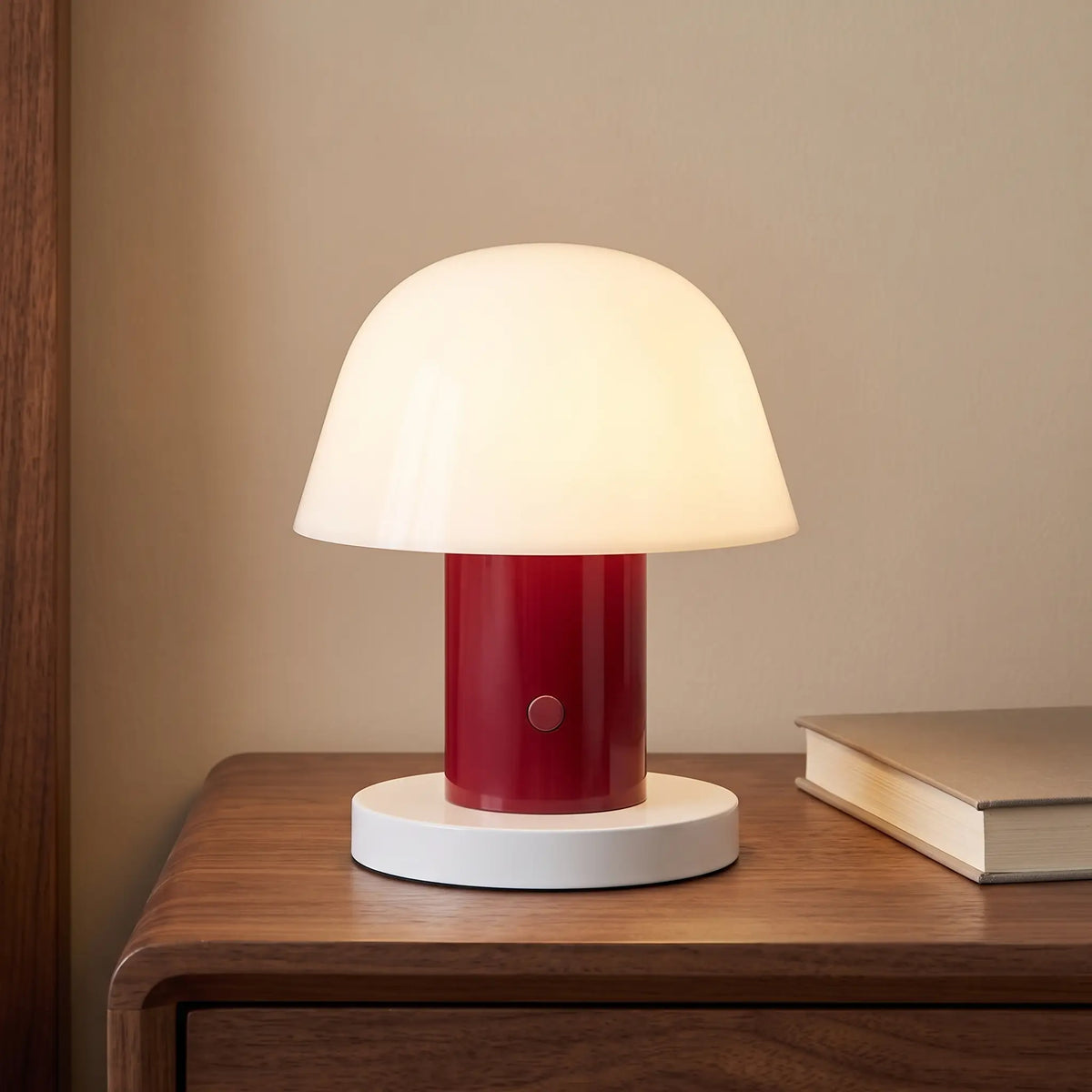 Rose red cordless mushroom lamp on a bedside table
