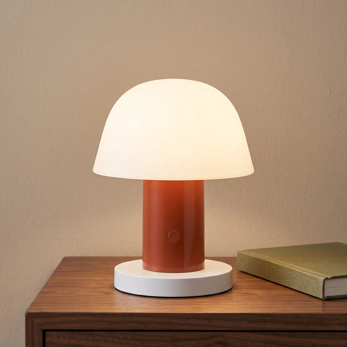 Brick red cordless mushroom lamp on a bedside table