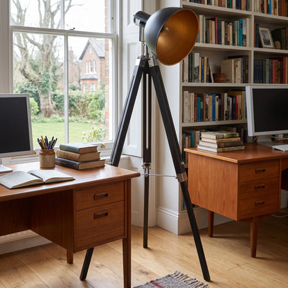 Retro tripod spotlight floor lamp in a home office in daylight